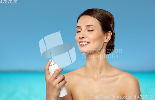 Image of beautiful young woman with facial spray or mist