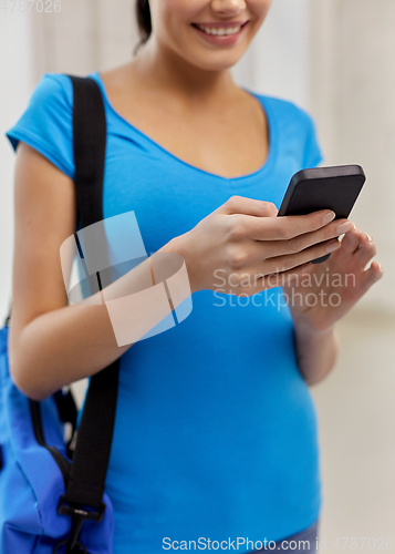 Image of close up of student woman with smartphone and bag