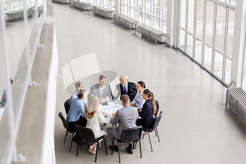 Image of architects with laptop and blueprint at office