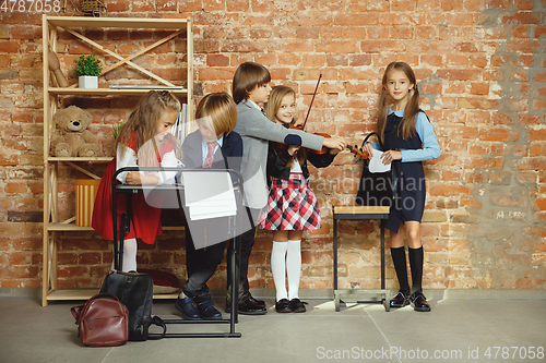 Image of Group of kids spending time after school together. Handsome frie