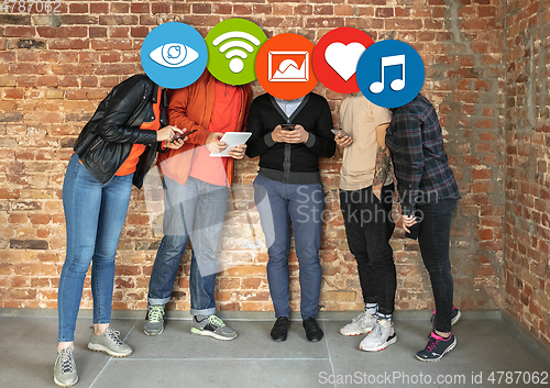 Image of Creative millenial people connecting and sharing social media. Modern UI icons as heads