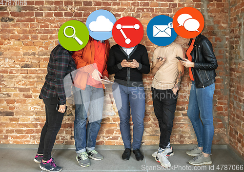 Image of Creative millenial people connecting and sharing social media. Modern UI icons as heads