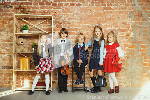 Image of Group of kids spending time after school together. Handsome friends resting after classes.