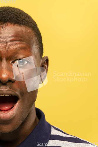 Image of African-american young man\'s close up portrait on yellow background