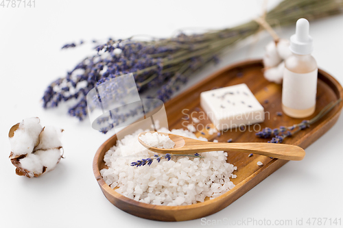 Image of sea salt, lavender soap and serum on wooden tray