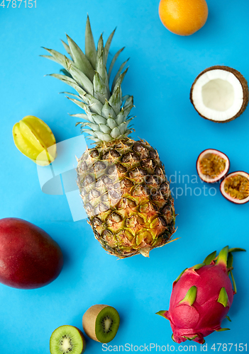 Image of pineapple with other fruits on blue background