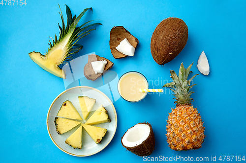 Image of pineapple, coconut and drink with paper straw