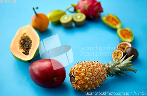 Image of different exotic fruits on blue background