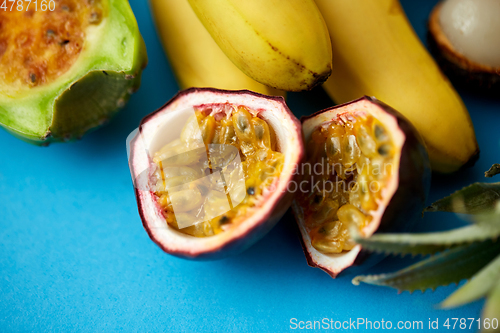 Image of cut passion fruit with other exotic fruits