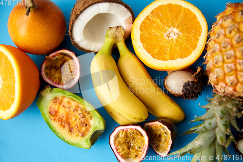 Image of different exotic fruits on blue background