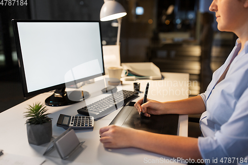 Image of designer with computer and pen tablet at office