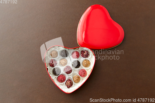 Image of candies in red heart shaped chocolate box