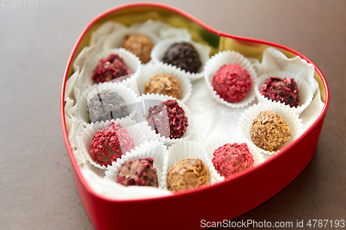 Image of candies in red heart shaped chocolate box