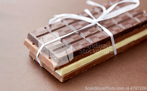 Image of different kinds of chocolate on brown background