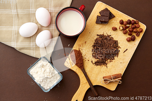 Image of chocolate, cocoa powder, milk, eggs and flour