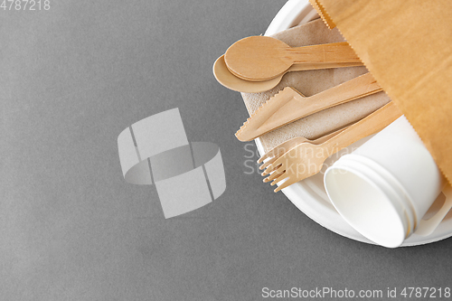 Image of wooden spoons, forks and knives on paper plate