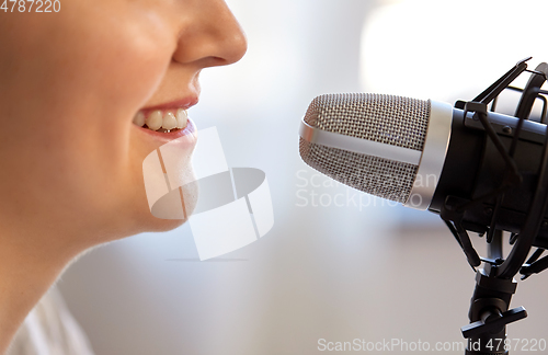 Image of close up of woman talking to microphone