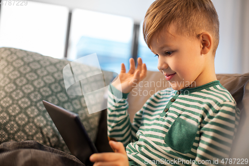 Image of happy little boy with tablet computer at home