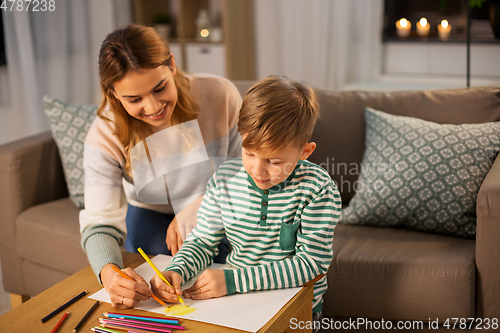 Image of mother and son with pencils drawing at home