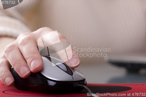 Image of Woman hand on a mouse