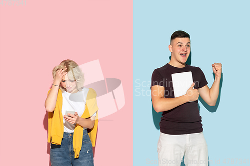 Image of Young emotional man and woman on pink and blue background