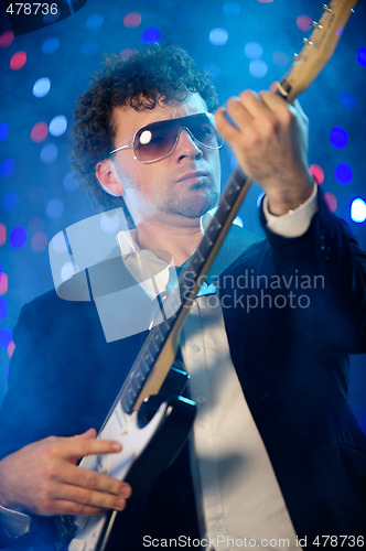 Image of Male with guitar on stage
