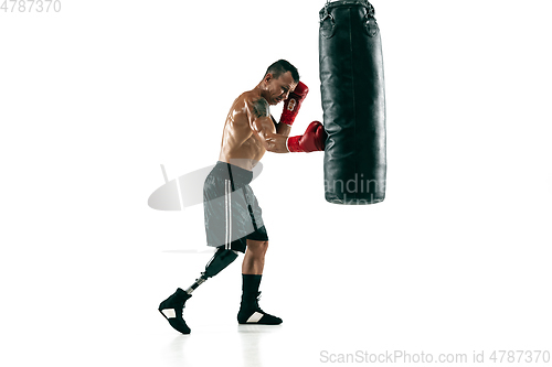 Image of Full length portrait of muscular sportsman with prosthetic leg, copy space. Male boxer in red gloves.