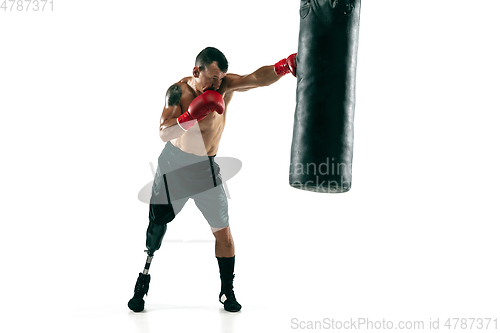 Image of Full length portrait of muscular sportsman with prosthetic leg, copy space. Male boxer in red gloves.