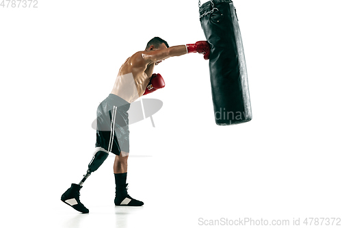 Image of Full length portrait of muscular sportsman with prosthetic leg, copy space. Male boxer in red gloves.