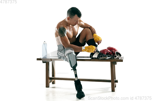 Image of Full length portrait of muscular sportsman with prosthetic leg, copy space. Male boxer in red gloves.