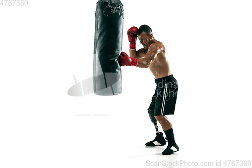 Image of Full length portrait of muscular sportsman with prosthetic leg, copy space. Male boxer in red gloves.