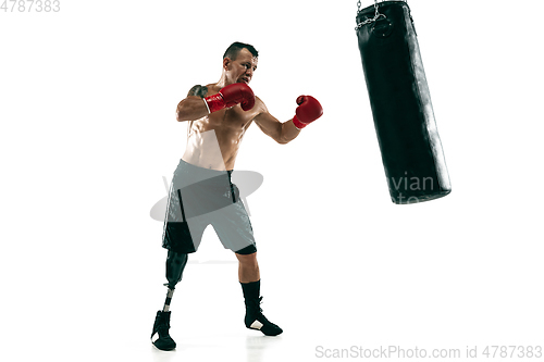 Image of Full length portrait of muscular sportsman with prosthetic leg, copy space. Male boxer in red gloves.