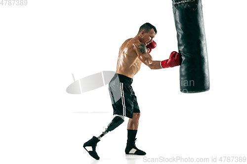 Image of Full length portrait of muscular sportsman with prosthetic leg, copy space. Male boxer in red gloves.