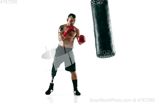 Image of Full length portrait of muscular sportsman with prosthetic leg, copy space. Male boxer in red gloves.