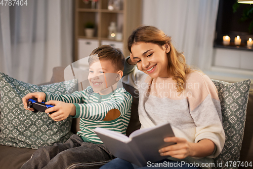 Image of happy mother with little son spending time at home