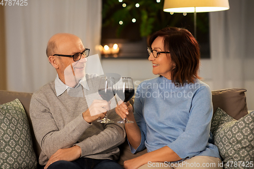 Image of happy senior couple with glasses of red wine