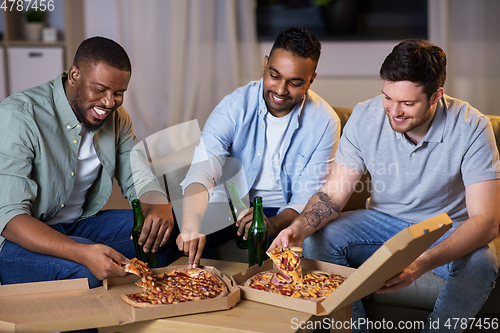 Image of happy male friends with beer eating pizza at home