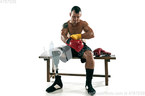 Image of Full length portrait of muscular sportsman with prosthetic leg, copy space. Male boxer in red gloves.