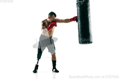 Image of Full length portrait of muscular sportsman with prosthetic leg, copy space. Male boxer in red gloves.