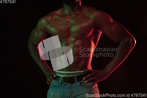 Image of Young african-american basketball player against dark background