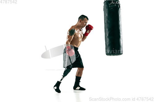 Image of Full length portrait of muscular sportsman with prosthetic leg, copy space. Male boxer in red gloves.