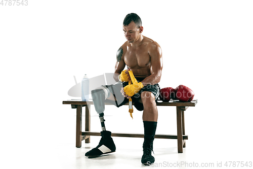 Image of Full length portrait of muscular sportsman with prosthetic leg, copy space. Male boxer in red gloves.