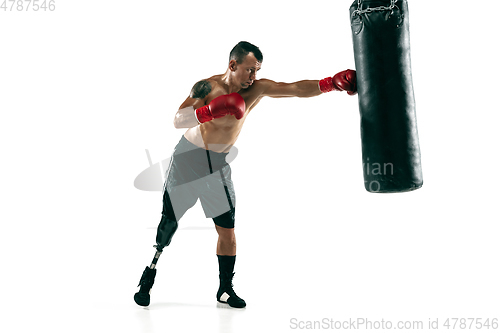 Image of Full length portrait of muscular sportsman with prosthetic leg, copy space. Male boxer in red gloves.