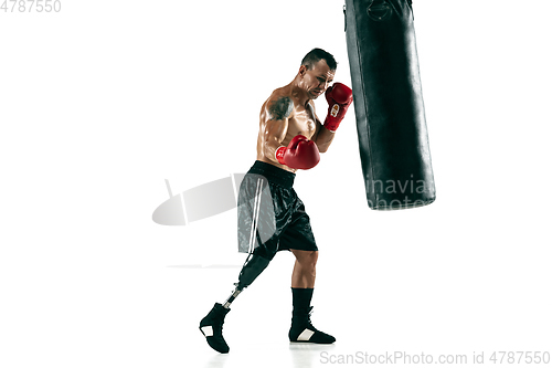 Image of Full length portrait of muscular sportsman with prosthetic leg, copy space. Male boxer in red gloves.