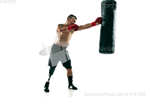 Image of Full length portrait of muscular sportsman with prosthetic leg, copy space. Male boxer in red gloves.