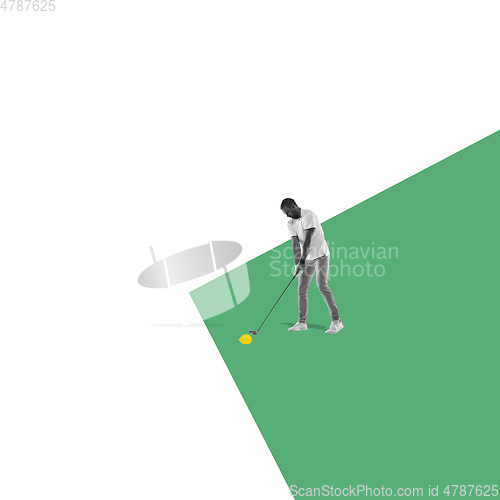 Image of Modern design, contemporary art collage. Inspiration, idea, trendy urban magazine style. Male golf player with lemon instead ball on bicolored background