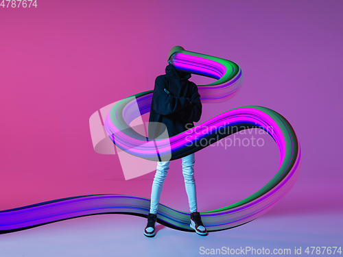 Image of Stylish man with long fluid flood on gradient background. Negative space to insert your text. Modern design. Contemporary colorful and conceptual bright art collage.