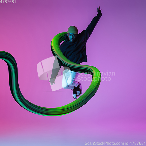 Image of Stylish man with long fluid flood on gradient background. Negative space to insert your text. Modern design. Contemporary colorful and conceptual bright art collage.