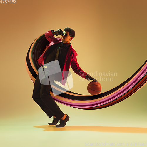 Image of Beautiful basketball player with long fluid flood on gradient background. Negative space to insert your text. Modern design. Contemporary colorful and conceptual bright art collage.