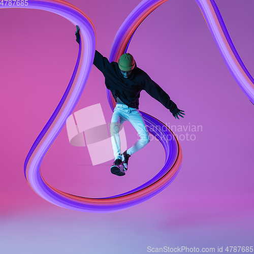 Image of Stylish man with long fluid flood on gradient background. Negative space to insert your text. Modern design. Contemporary colorful and conceptual bright art collage.